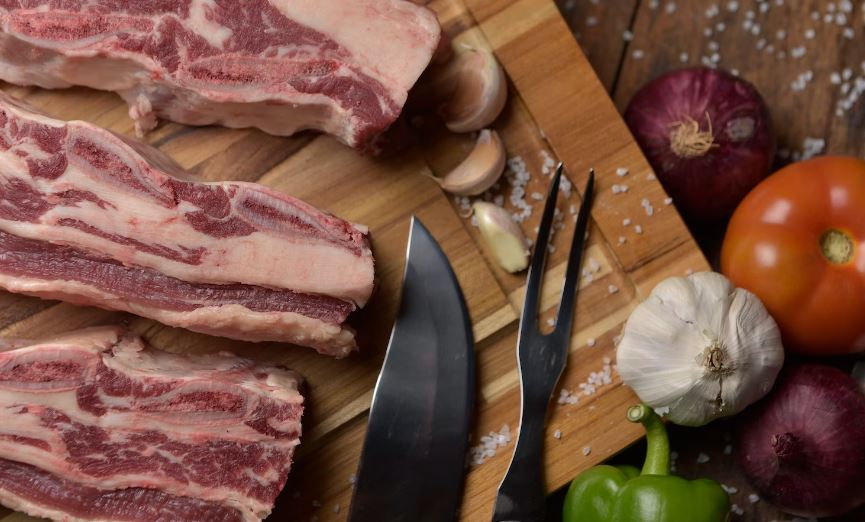 sliced raw meat on chopping board