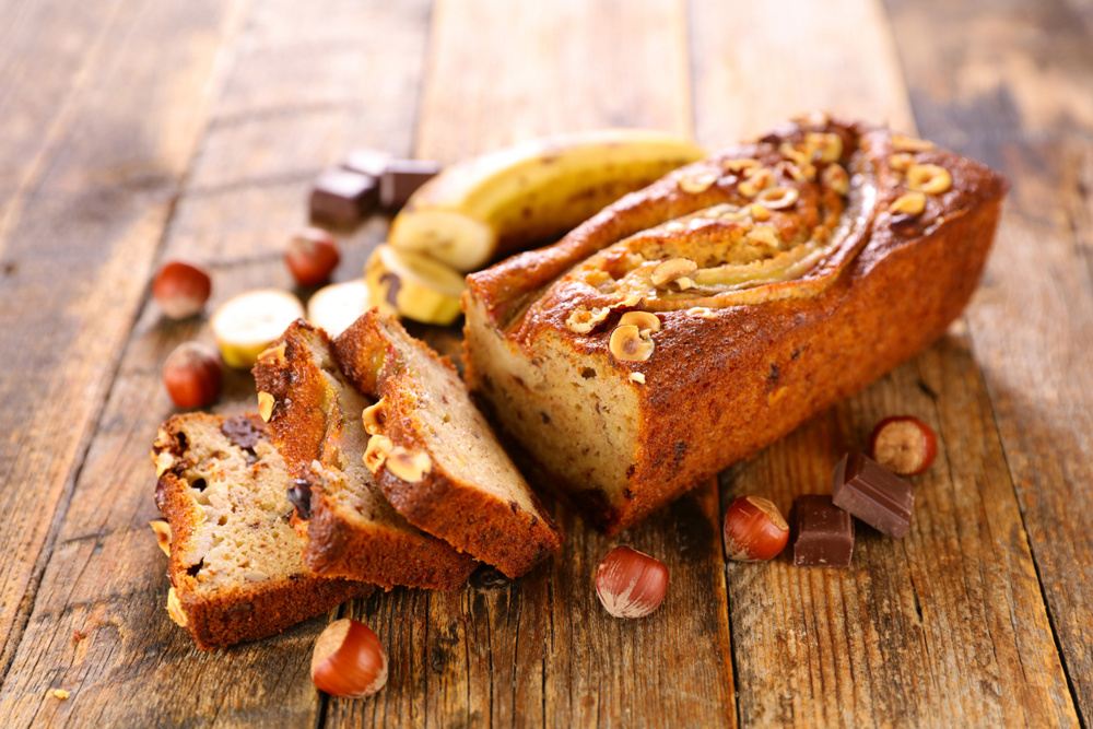Banana bread with hazelnut on wood background