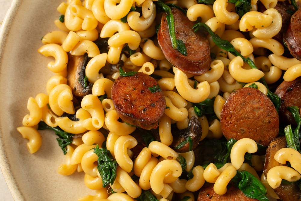 A top down view of a plate of gluten-free elbows and Spanish chorizo